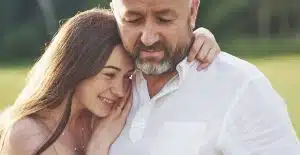 handsome old man and beautiful young girl are hugging daughter and picture id1135501420