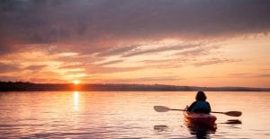 woman in a kayak on the river on the scenic sunset picture id1059748342