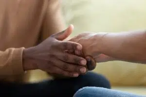 African husband holding biracial wife hands with care and love