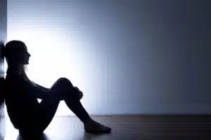 girl sitting alone in a dark room