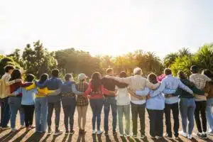 people standing in a row with their arms around each other